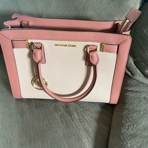 Satchel has pocket on outside and inside new with tags. Does not have strap